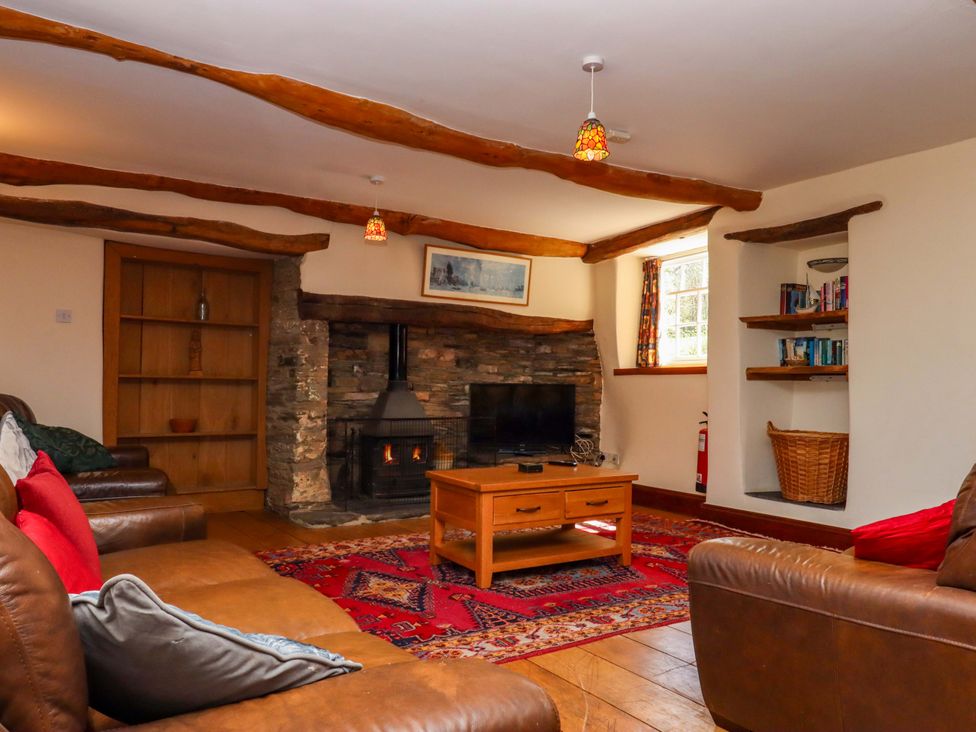 A living room with a fireplace and furniture at East Bickleigh in Halwell