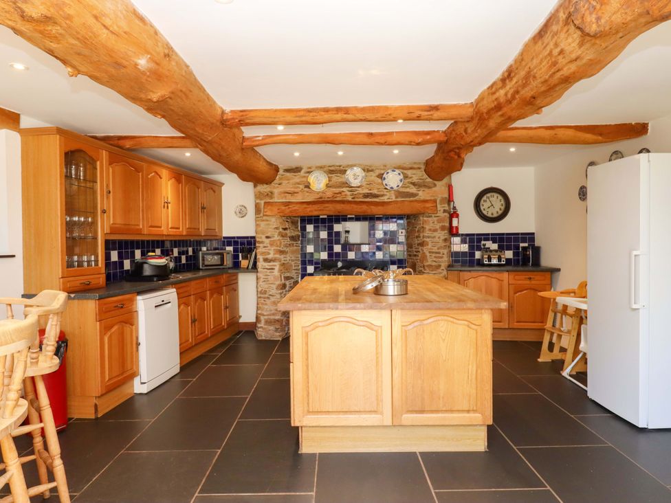 A kitchen with wooden cabinets and a large island at East Bickleigh in Halwell
