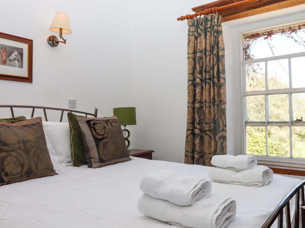 A bedroom with a bed and window at East Bickleigh in Halwell