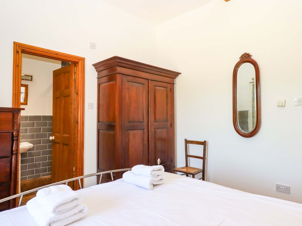 A bedroom with a bed and wardrobe at East Bickleigh in Halwell