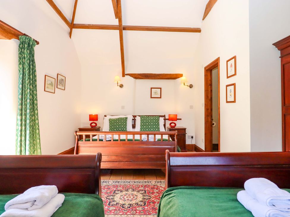 A bedroom with two beds and wooden furniture at East Bickleigh in Halwell