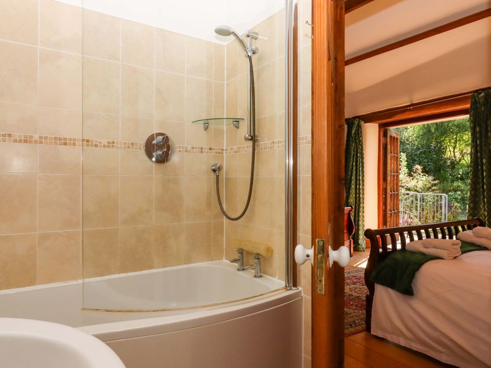 A bathroom with a shower and bathtub at East Bickleigh Halwell