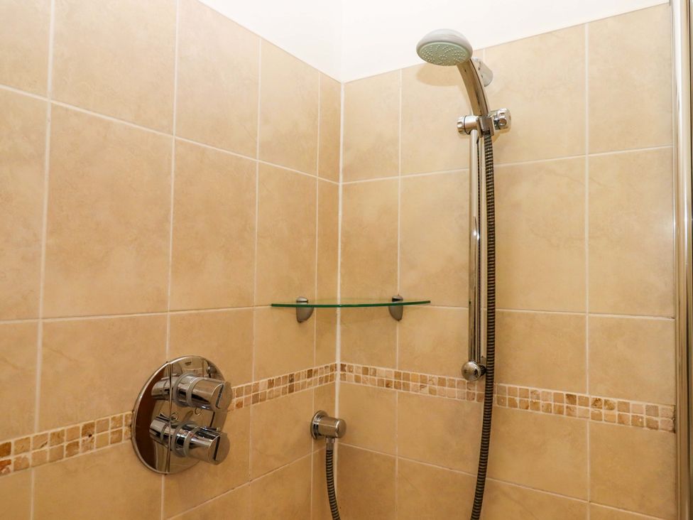 A shower with glass shelf and controls at East Bickleigh in Halwell