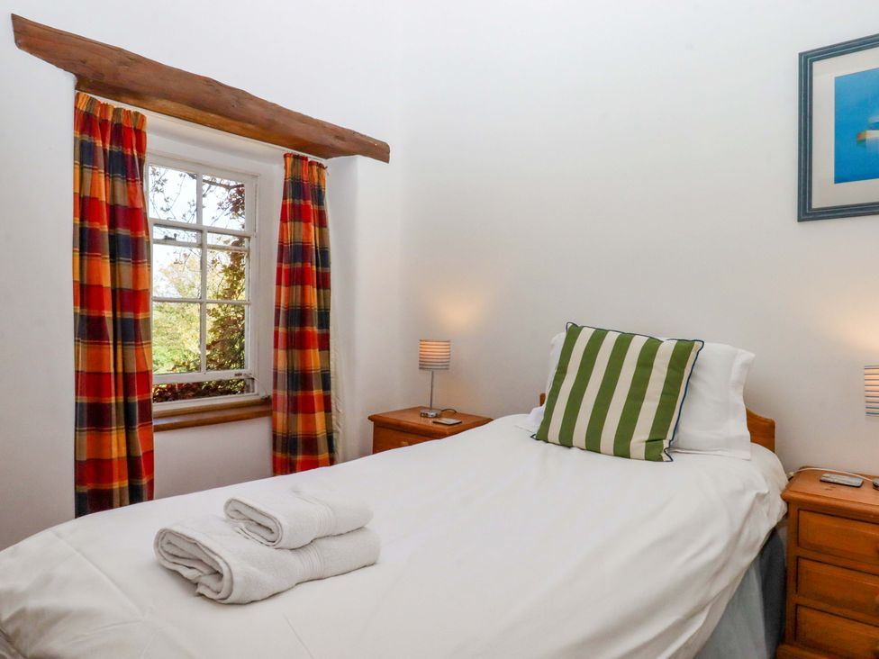 A bedroom with a single bed and a window at East Bickleigh in Halwell