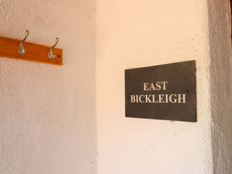 A wall with hooks and nameplate at East Bickleigh in Halwell
