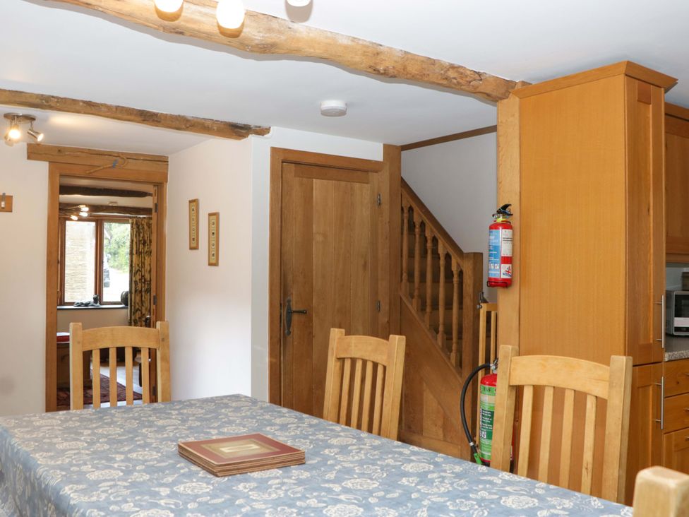 A dining room with a table and chairs at The Hay Barn Halwell