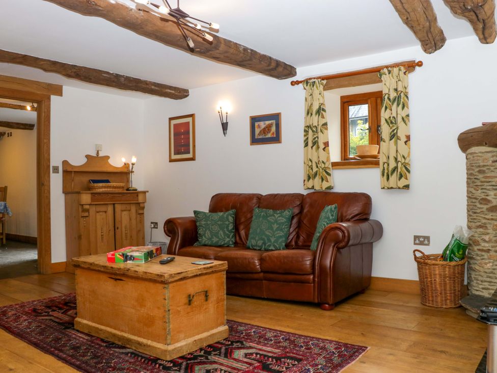 A living room with a sofa and coffee table at The Hay Barn in Halwell