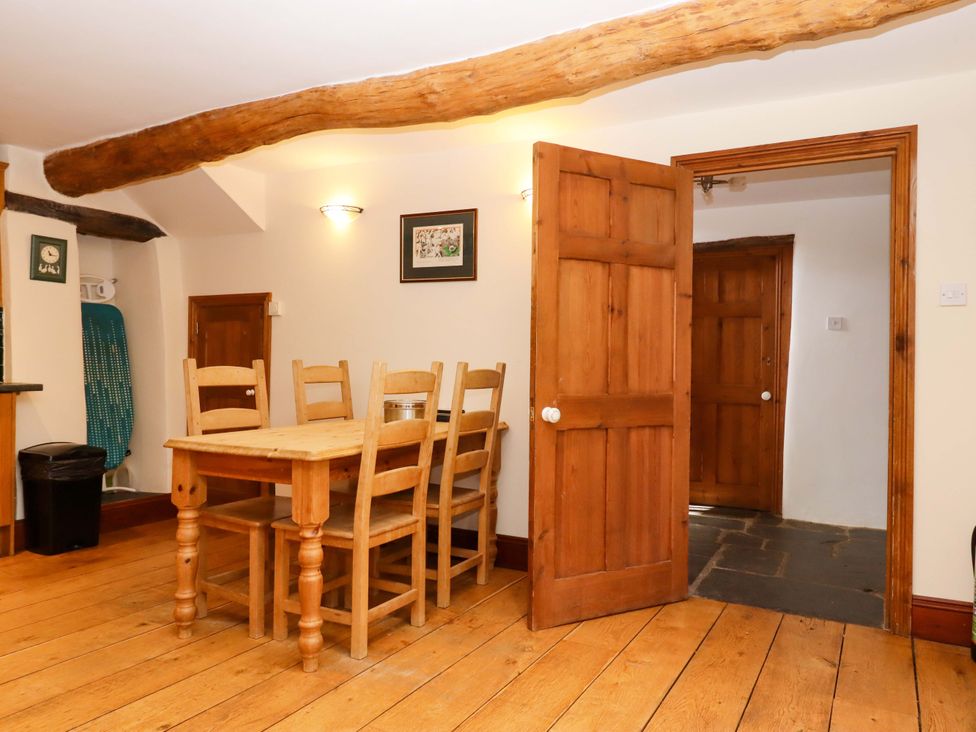 A dining room with a table and chairs at Oak Tree in Halwell
