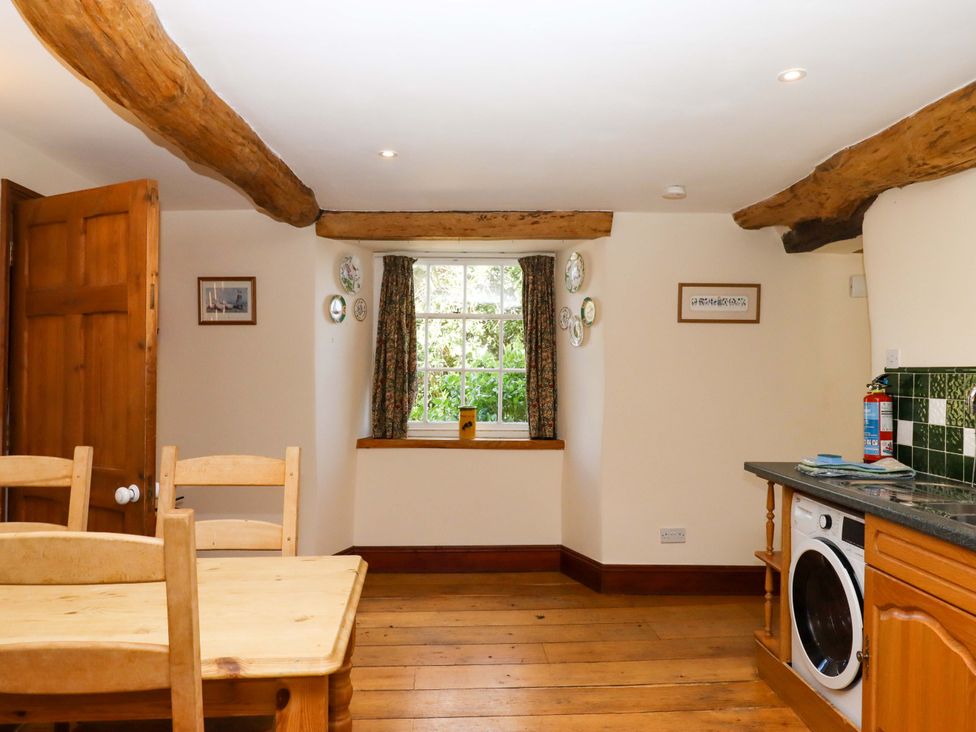 A kitchen with a window and washing machine at Oak Tree in Halwell