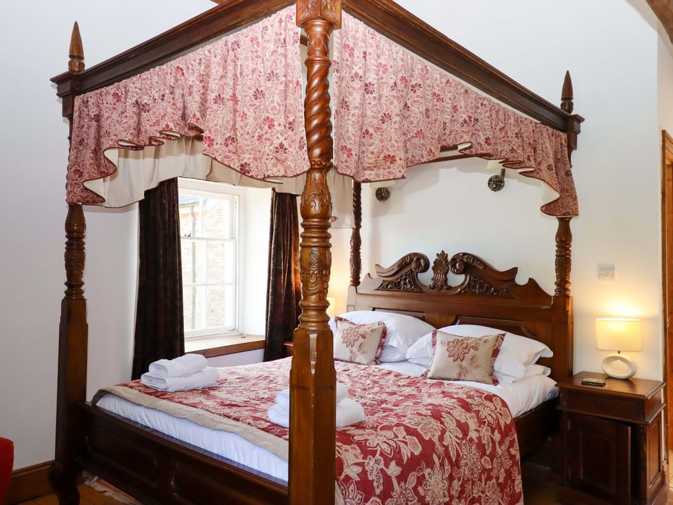 A bedroom featuring a canopy bed at Oak Tree in Halwell