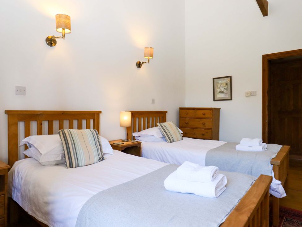 A bedroom with two beds and a dresser at Oak Tree in Halwell