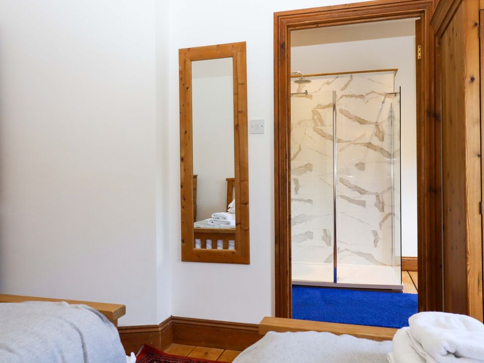 A bathroom with a shower and mirror at Oak Tree in Halwell