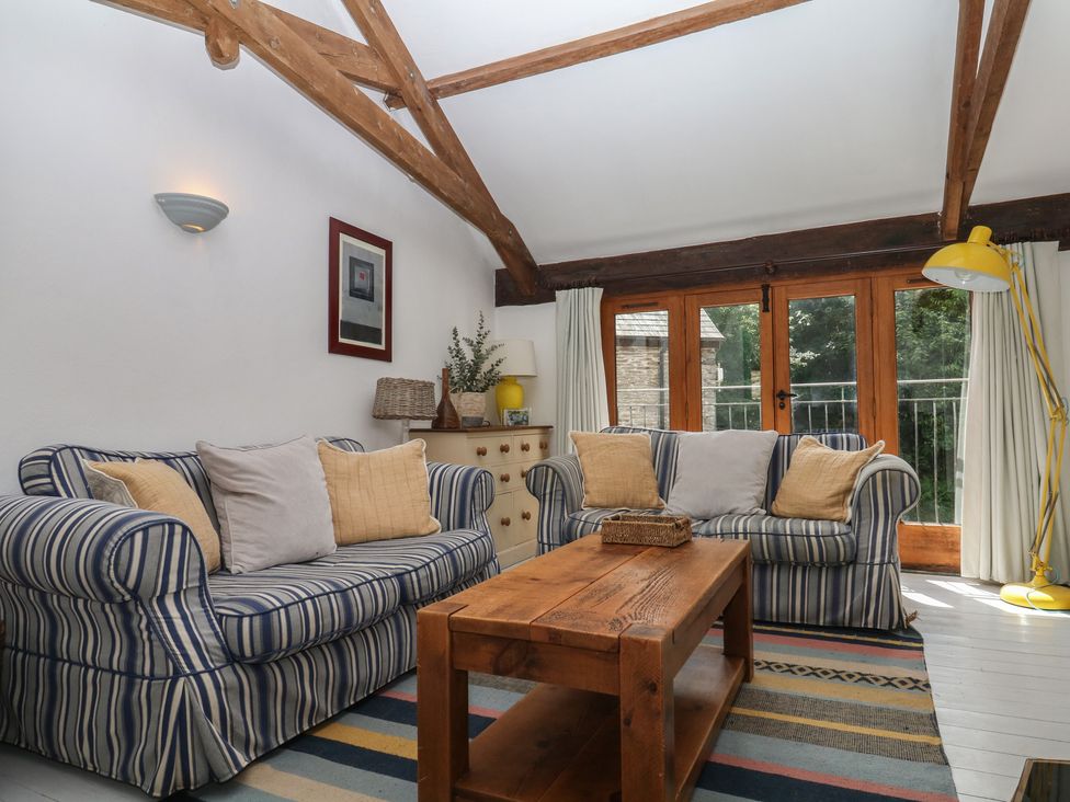 A living room with sofas and a coffee table at Fixit Cottage in Kingsbridge