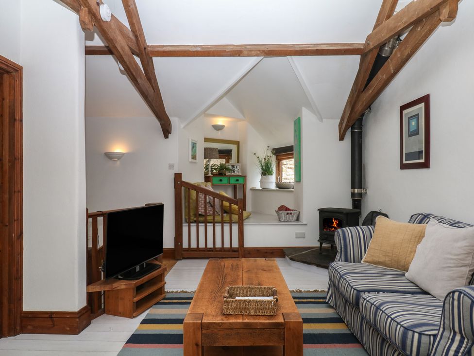 A living room with a sofa and coffee table at Fixit Cottage in Kingsbridge