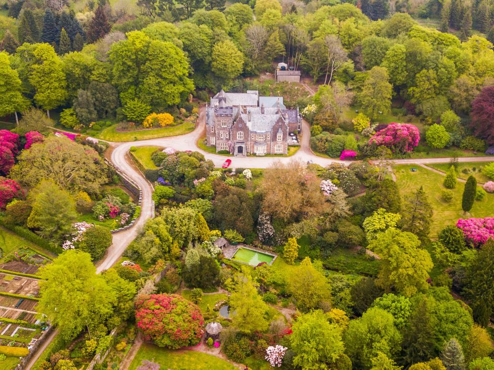 An aerial view of a house surrounded by gardens at The Clock House in Ivybridge