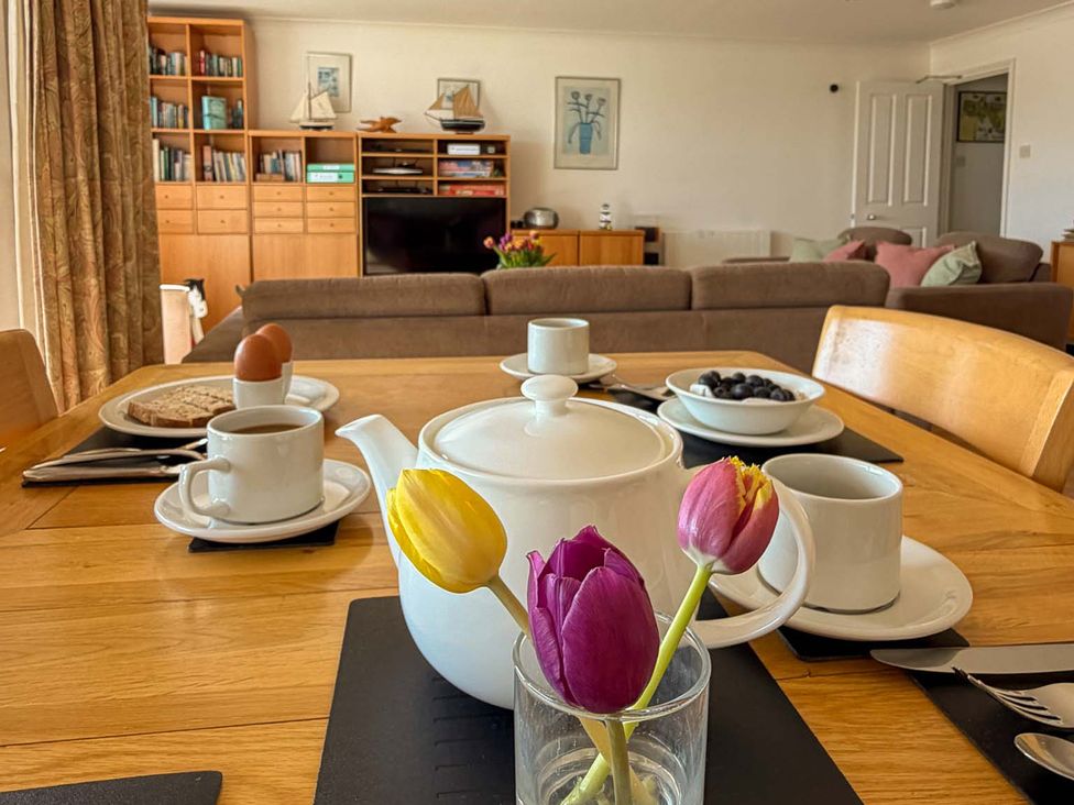 A dining room with a table set for breakfast at 5 Burgh Island Causeway Bigbury-on-Sea