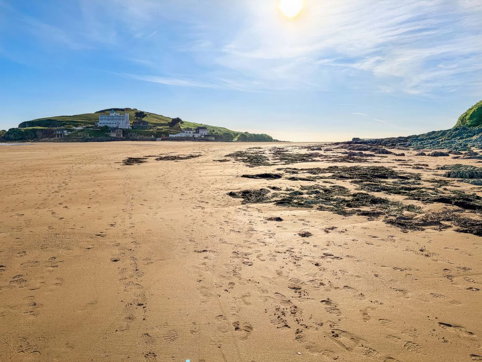 A beach with sand and rocks in the foreground at 5 Burgh Island Causeway Bigbury-on-Sea