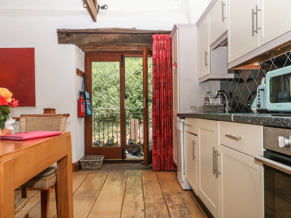 A kitchen with a table and chairs at Mixit Cottage in Kingsbridge