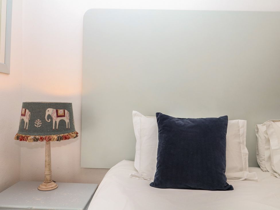 A bedroom with a pillow and a lamp at Mixit Cottage in Kingsbridge