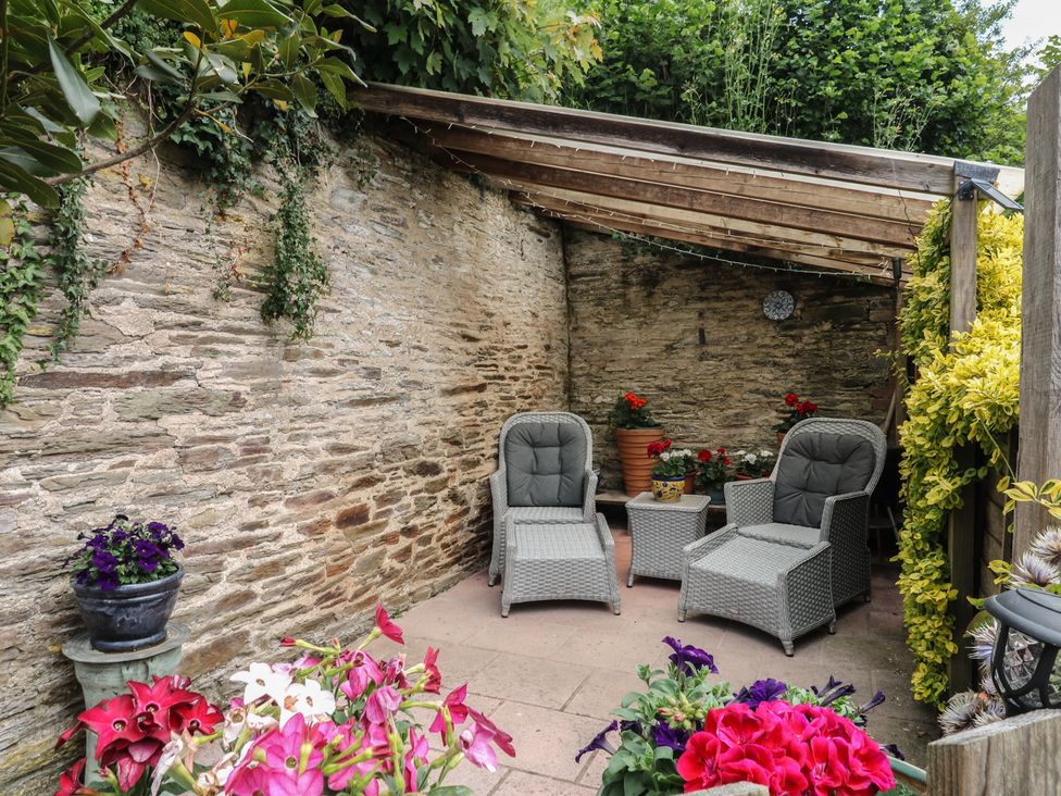 A garden with outdoor seating and flowers at Mixit Cottage in Kingsbridge