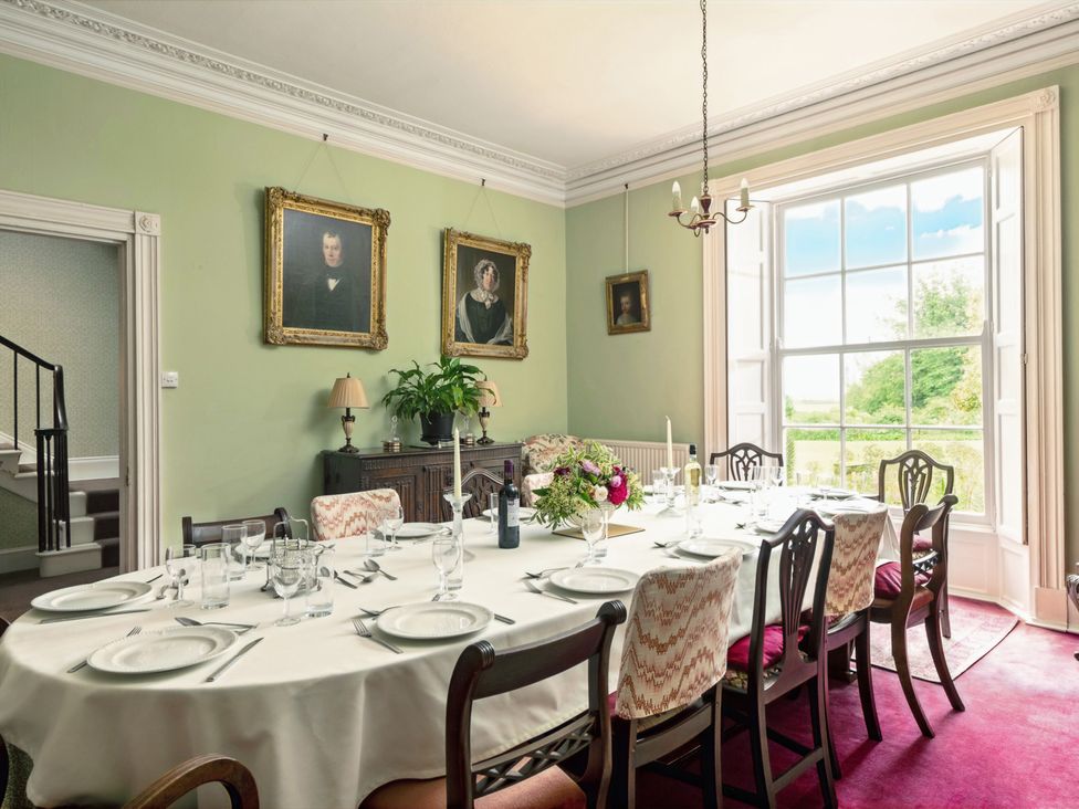 A dining room with a table set for a meal at Parnacott in Holsworthy