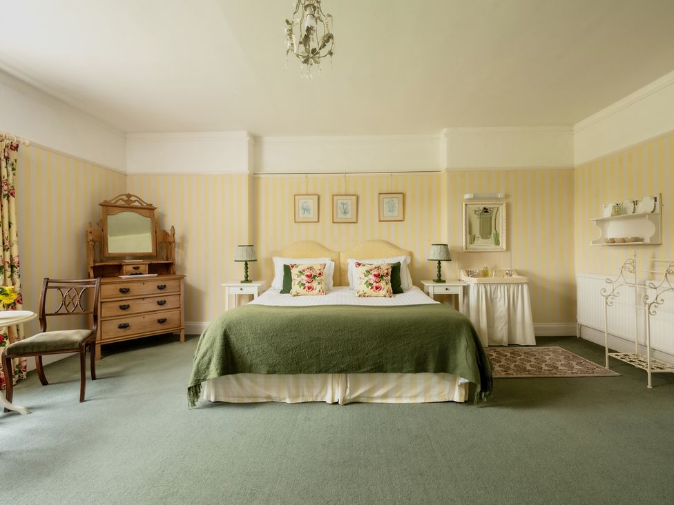 A bedroom with a bed and dresser at Parnacott in Holsworthy