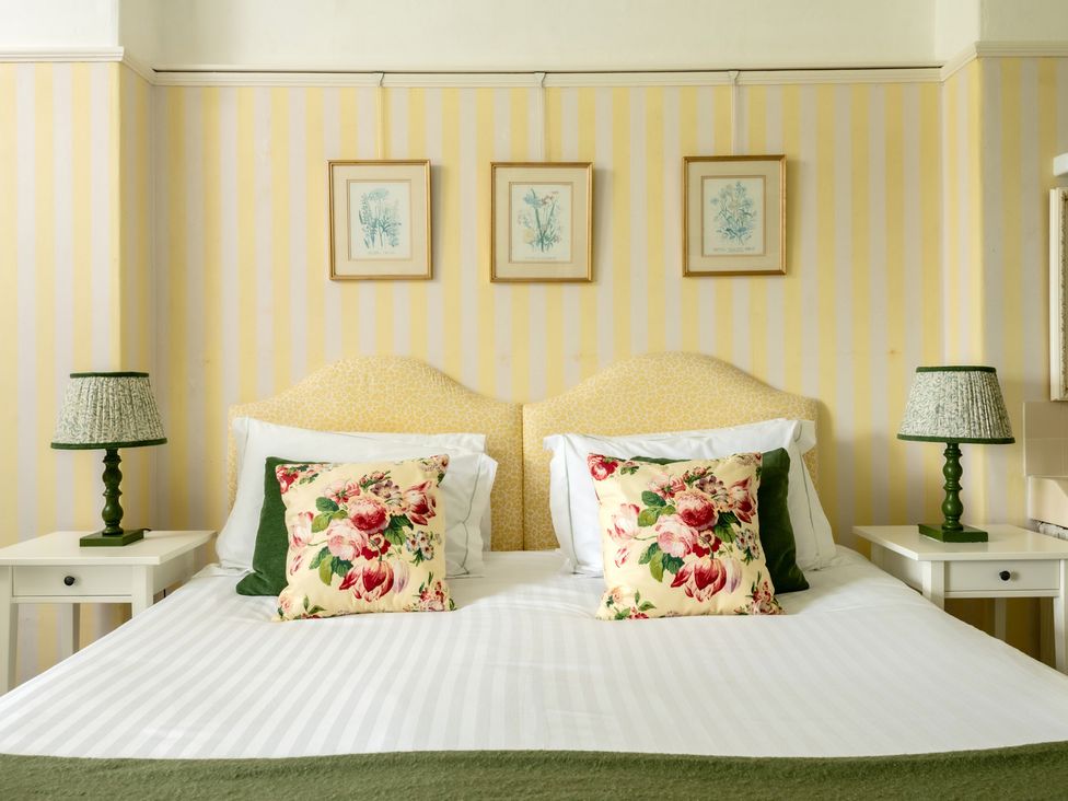A bedroom with a bed and bedside tables at Parnacott in Holsworthy