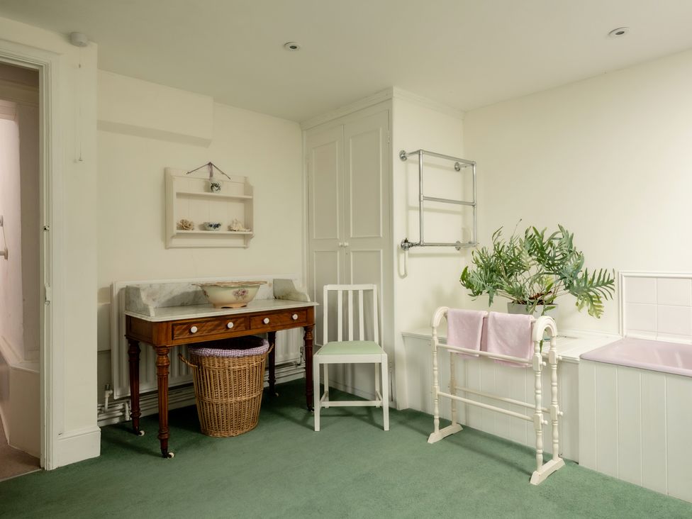 A bathroom with a wash basin and towel rack at Parnacott in Holsworthy