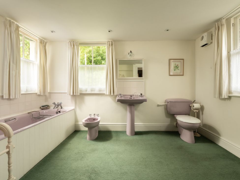 A bathroom with a bathtub, toilet, sink, and bidet at Parnacott in Holsworthy