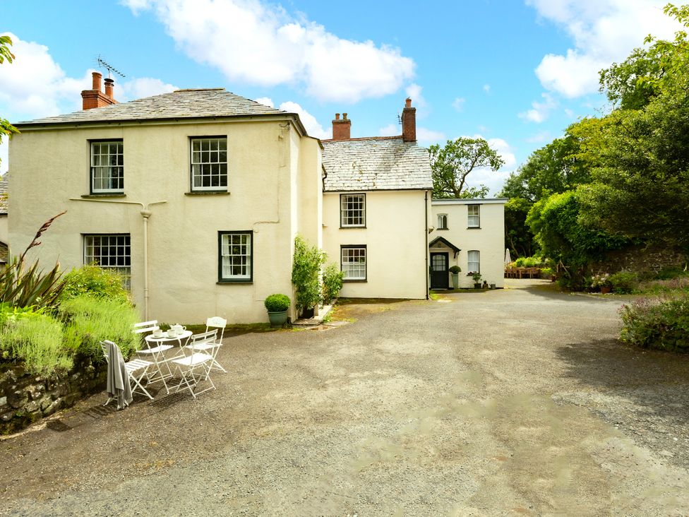 An outdoor area with a house and seating at Parnacott in Holsworthy