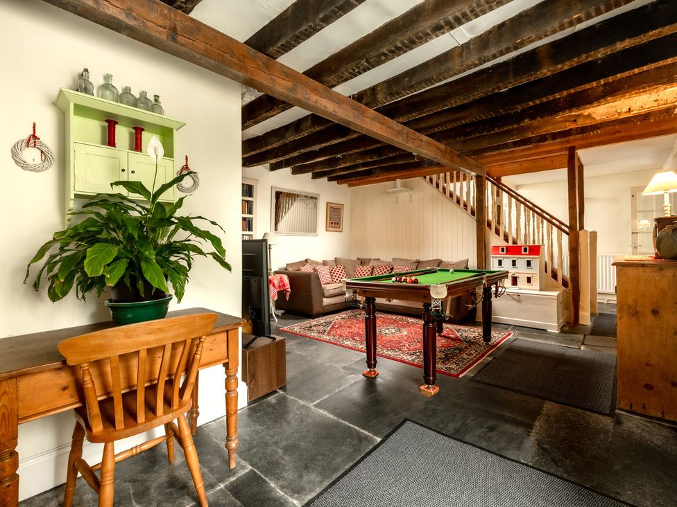 A snug with a pool table and sofa at Parnacott in Holsworthy