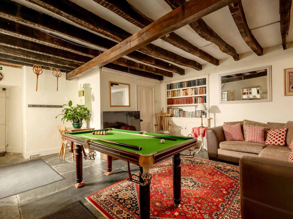 A recreation room with a billiard table and sofa at Parnacott in Holsworthy