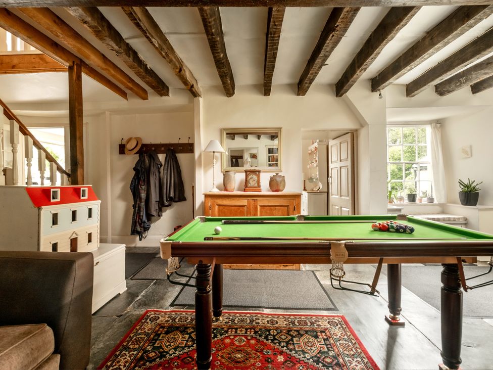 A game room with a pool table and cabinet at Parnacott in Holsworthy