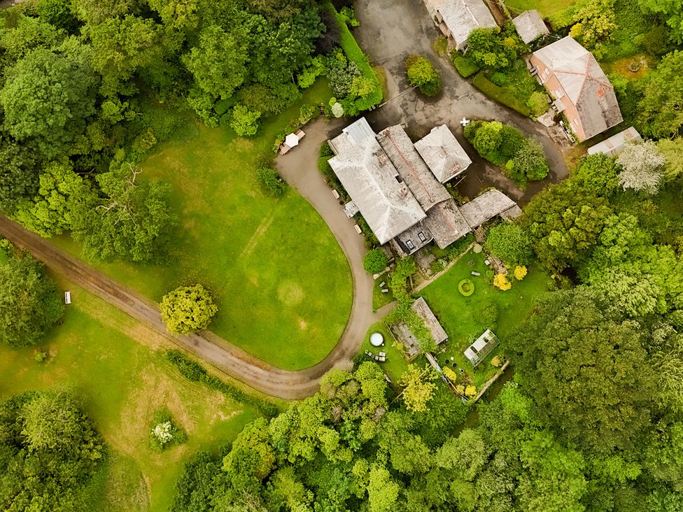 An aerial view of a property surrounded by trees and a pathway at Parnacott in Holsworthy
