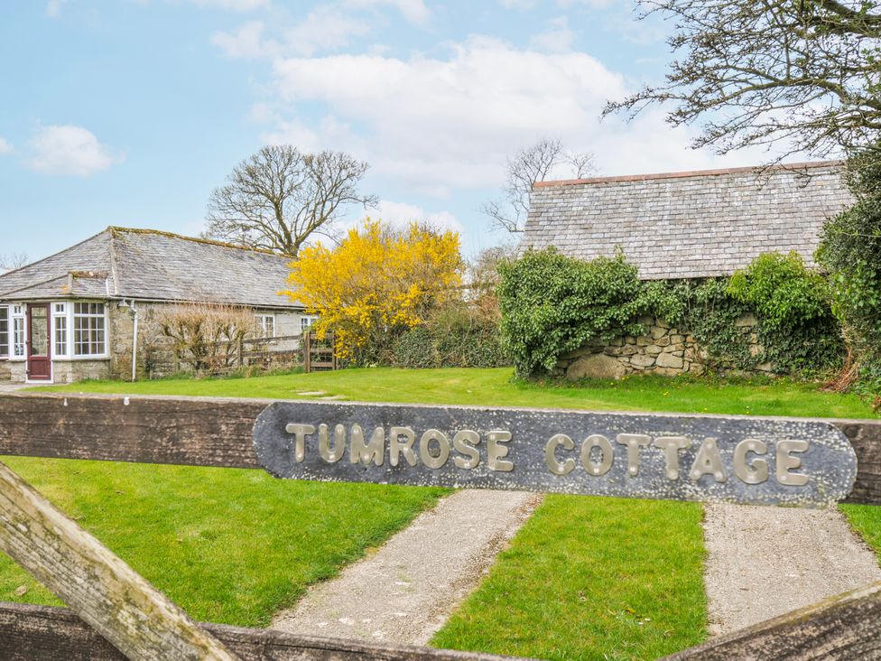 An outdoor view of a cottage with a pathway at Tumrose Cottage in Blisland