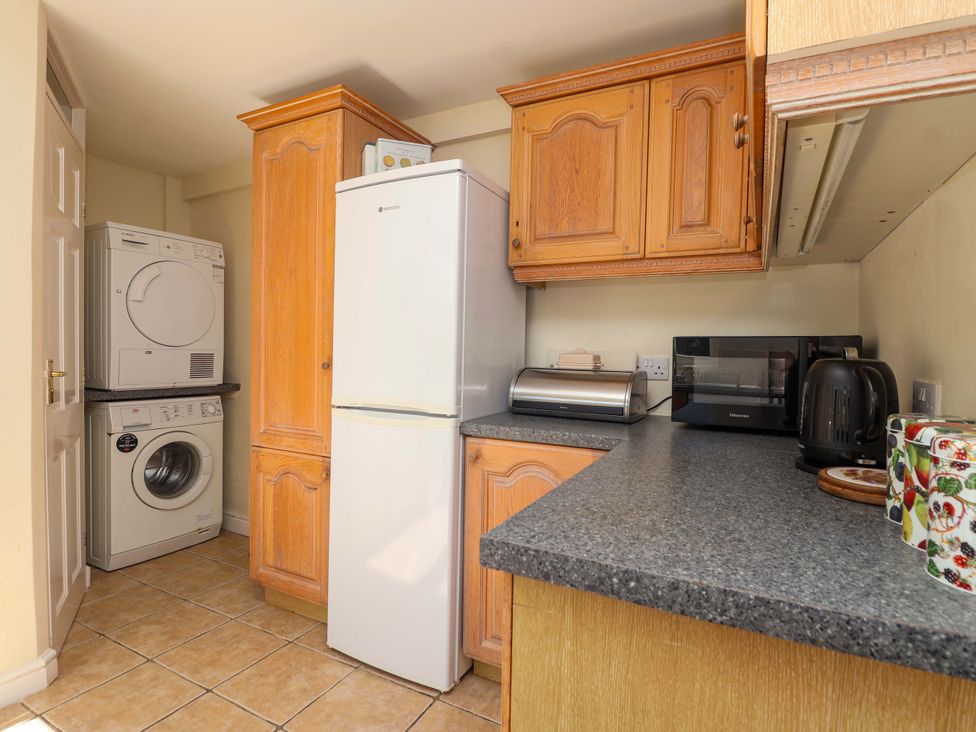 A kitchen with appliances and cabinetry at Agar Cottage, Trelights, near Port Isaac