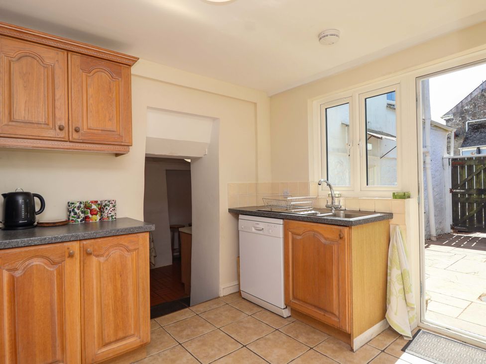 A kitchen with cabinets and appliances at Agar Cottage, Trelights, near Port Isaac