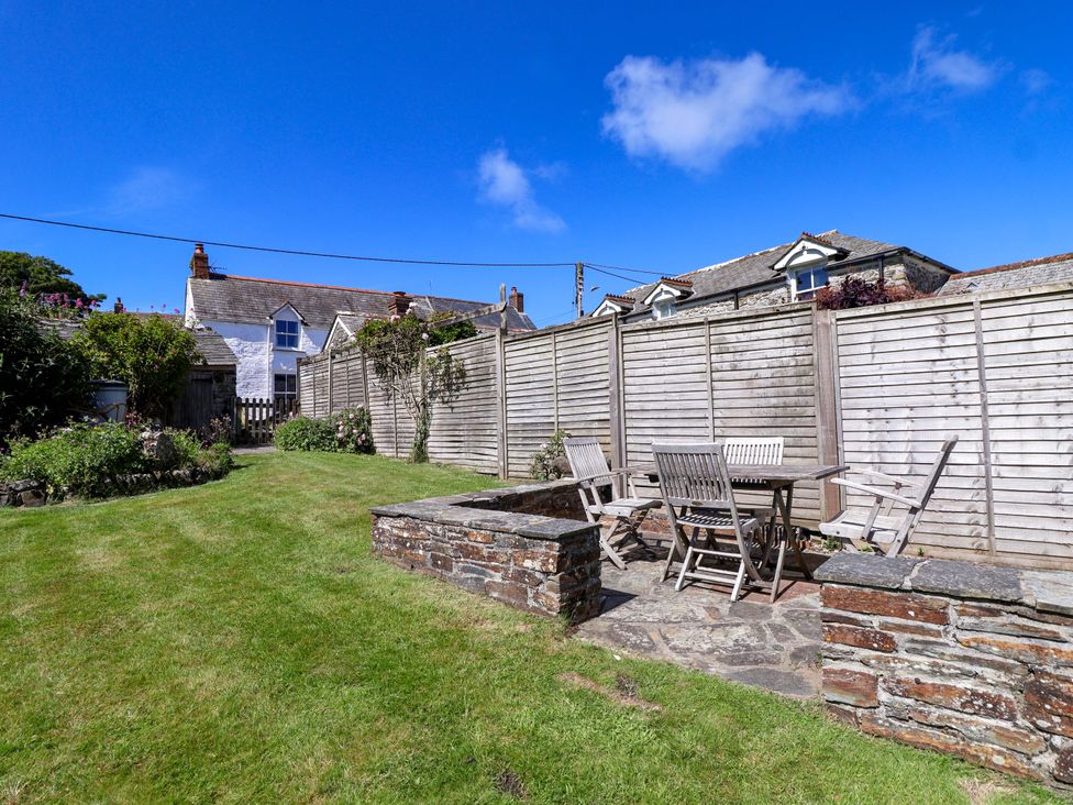 A garden with a table and chairs at Agar Cottage in Trelights, near Port Isaac