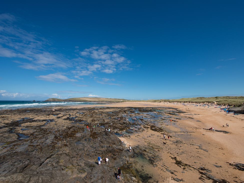 A beach with rocks and people at Grandpa Dickson's in Little Petherick