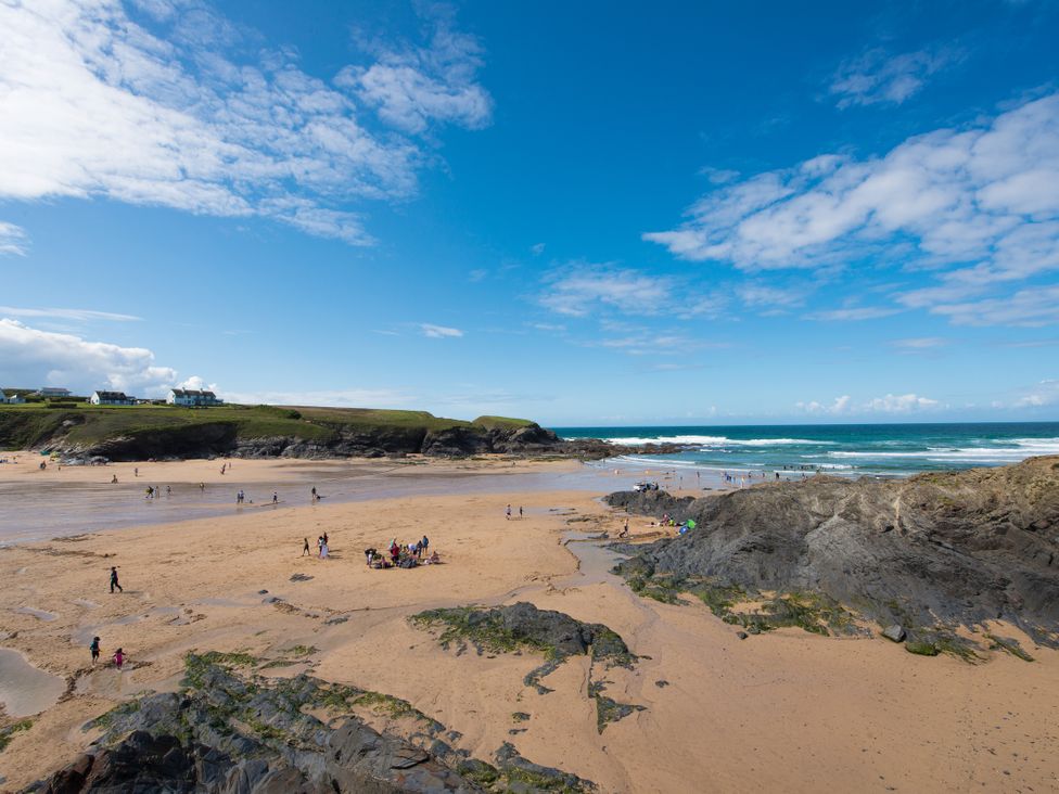 A beach scene with people enjoying the water at Grandpa Dickson's in Little Petherick