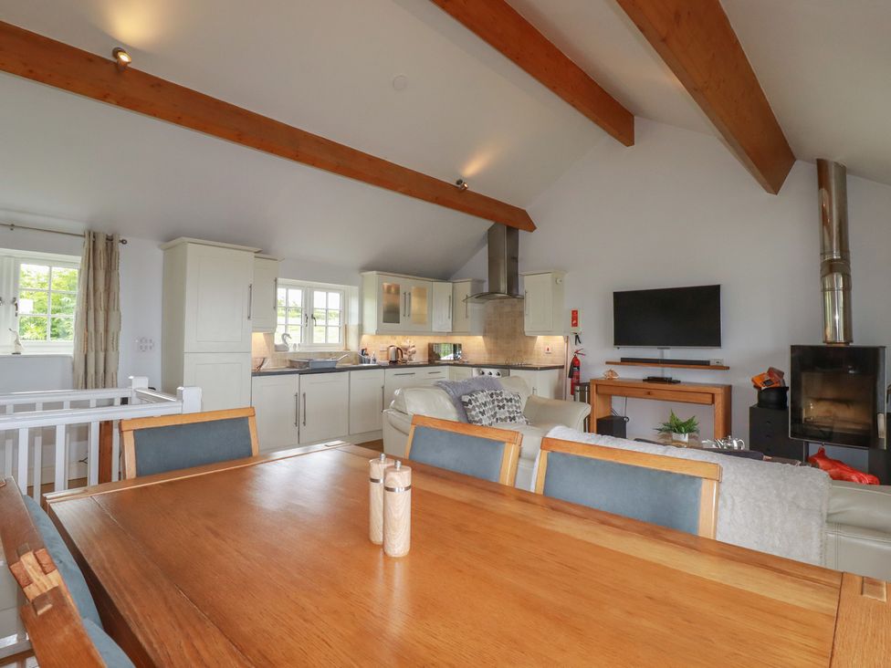 A kitchen with a table and sofa at Atlantic View in Tintagel