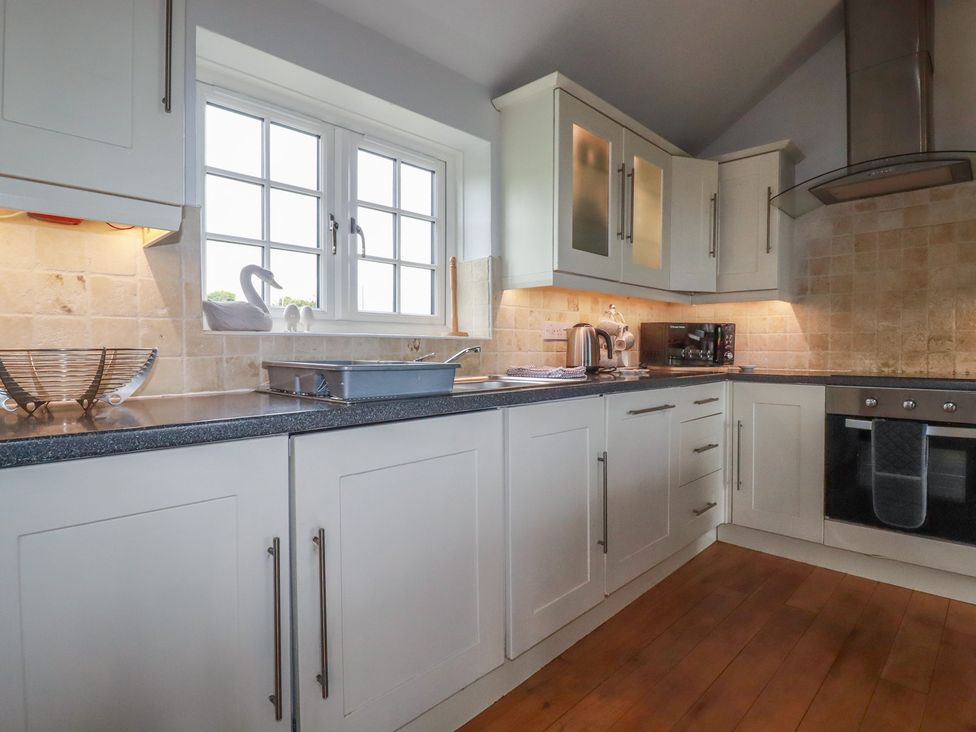 A kitchen with cabinets and appliances at Atlantic View in Tintagel