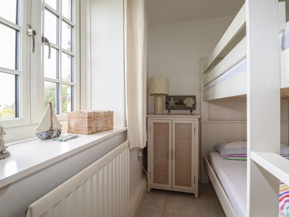 A bedroom with a bed and decorative items at Atlantic View in Tintagel