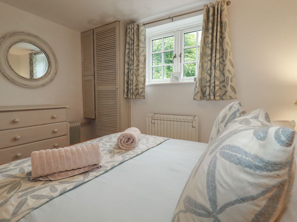 A bedroom with a bed and dresser at Atlantic View in Tintagel