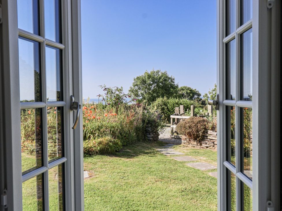 A view of a garden through an open door at Atlantic View in Tintagel