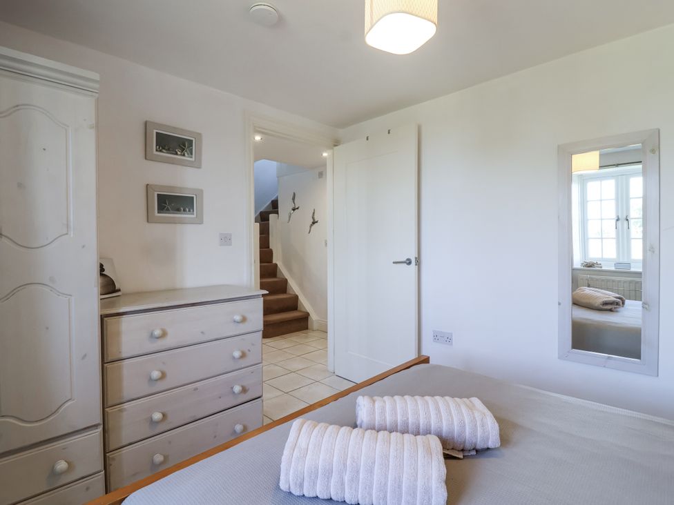 A bedroom with towels on the bed at Atlantic View in Tintagel