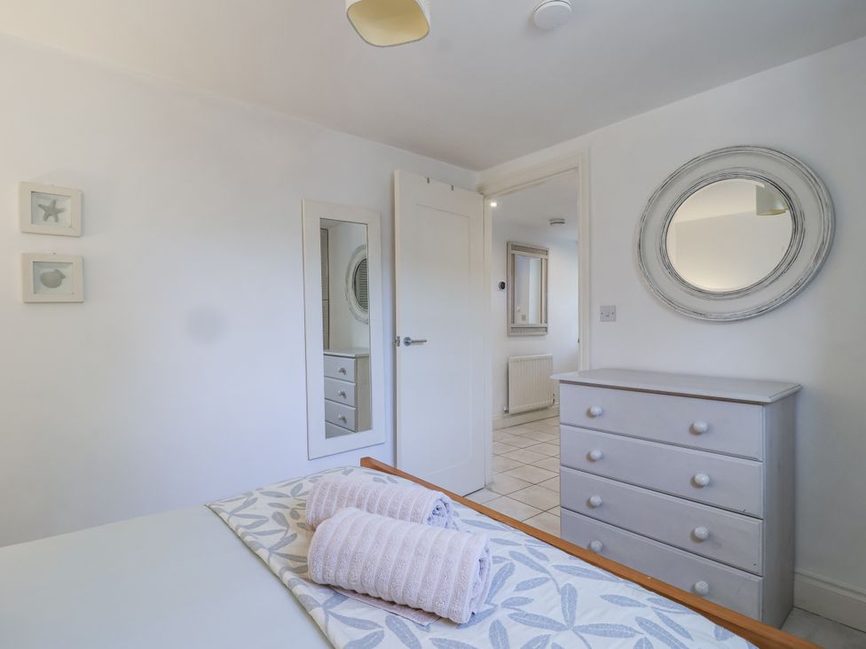 A bedroom with a bed and towels on it at Atlantic View in Tintagel