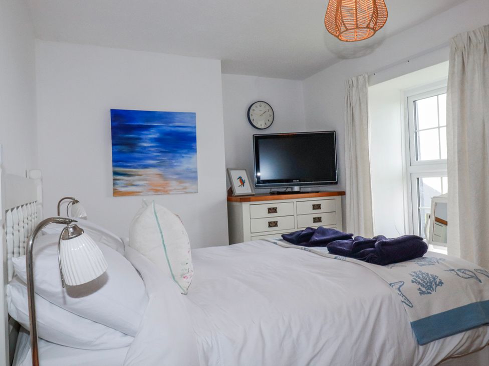 A bedroom with a bed and TV at Kingfisher Cottage in Edmonton, near Wadebridge