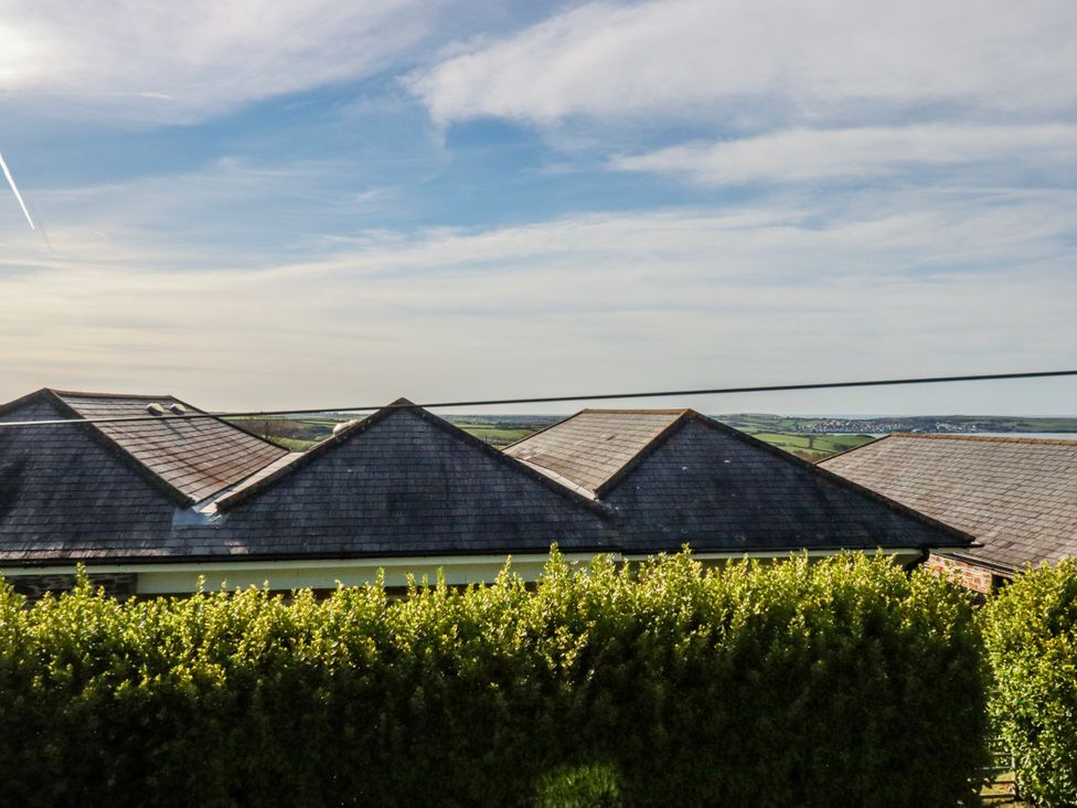 View of roofs and hedge at Kingfisher Cottage, Edmonton, near Wadebridge