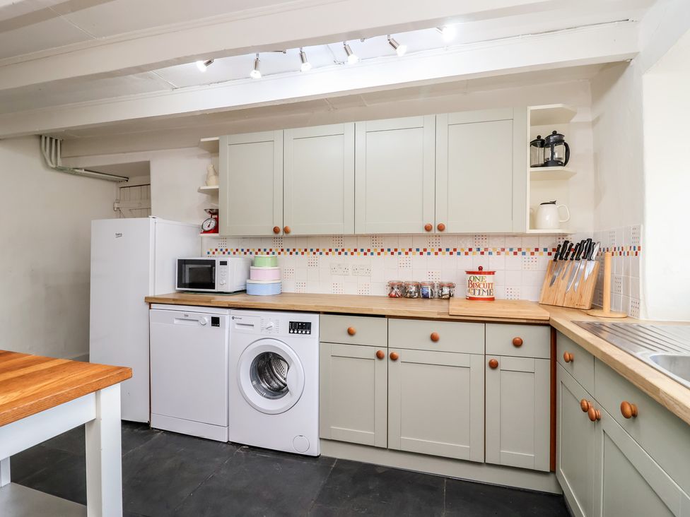 A kitchen with appliances and cabinetry at Tregonhawke Farmhouse Millbrook